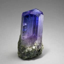 Raw Tanzanite crystal specimen showing natural mineral texture and coloring